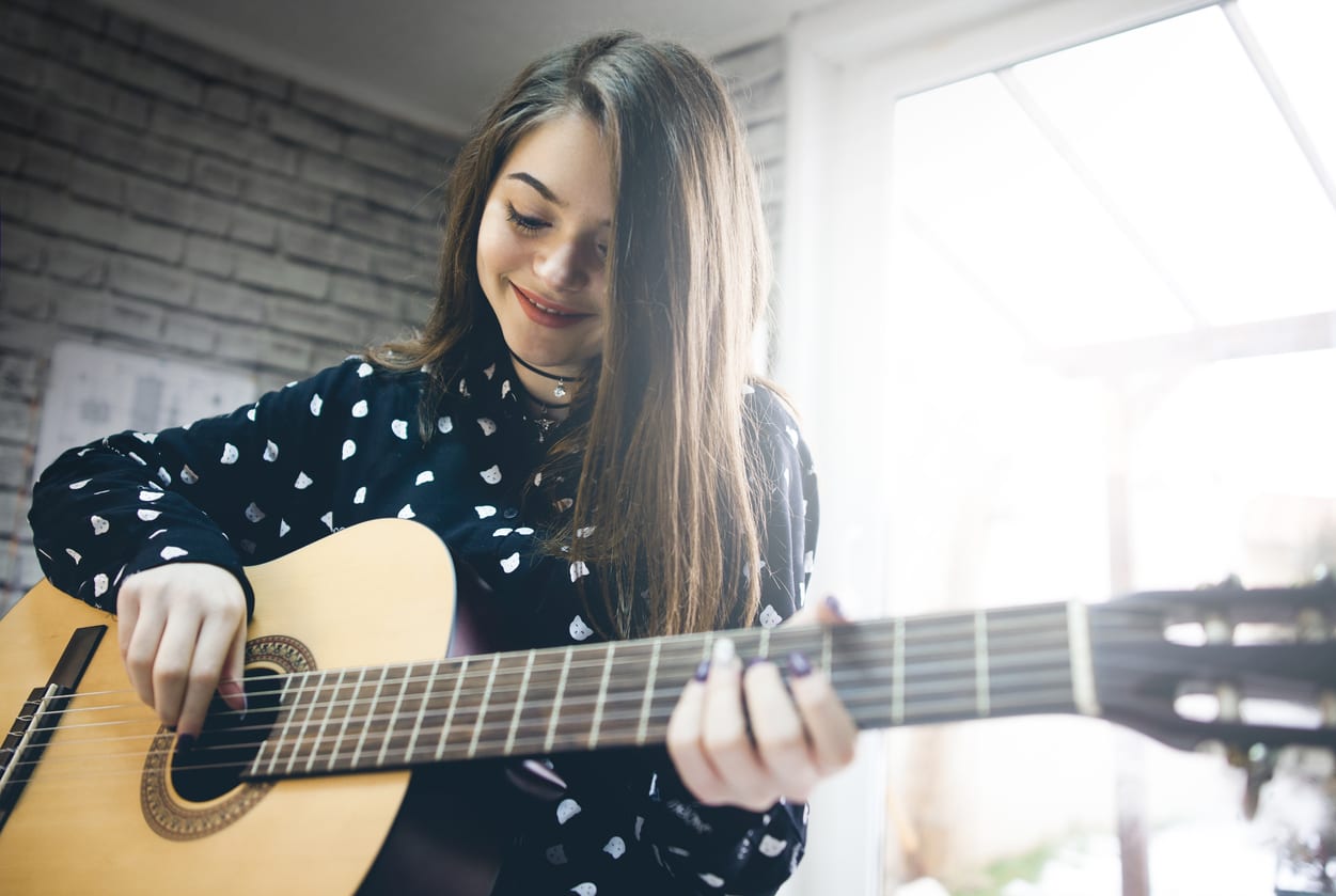 http://www.grooveacademy.ca/wp-content/uploads/2019/01/Girl-Playing-Guitar-1.jpg